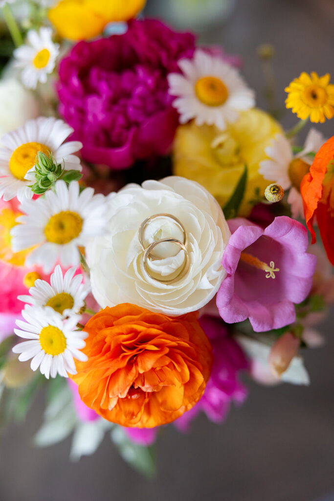 Wedding rings on a colorful bouquet