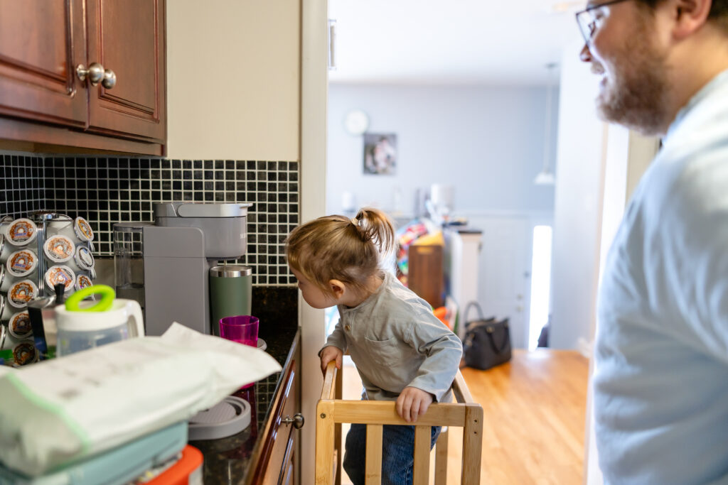 Child watching father make coffee