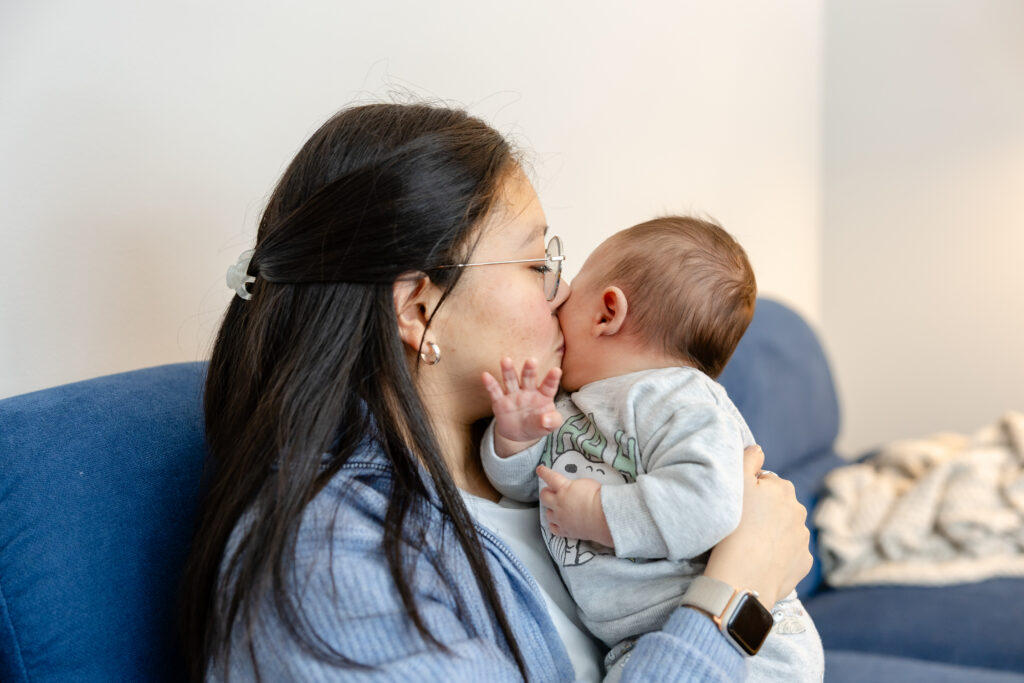 Mother kissing baby forehead