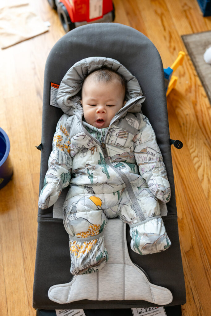 Baby in winter coat yawning