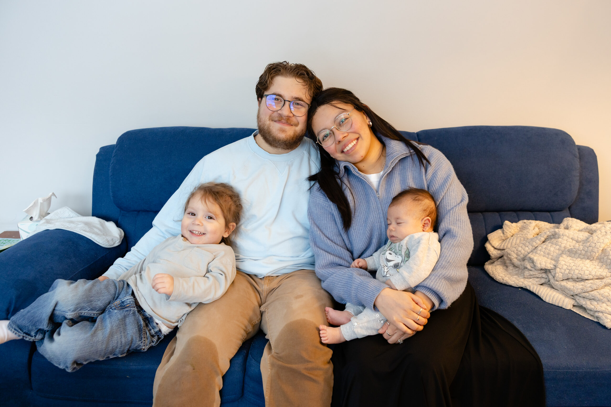 Family sitting on the couch together